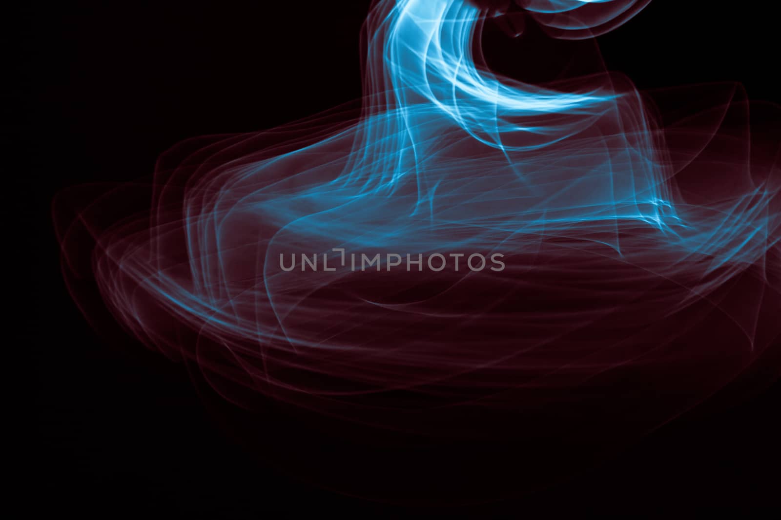 Light painted glowing abstract blue and red curved lines on a black background