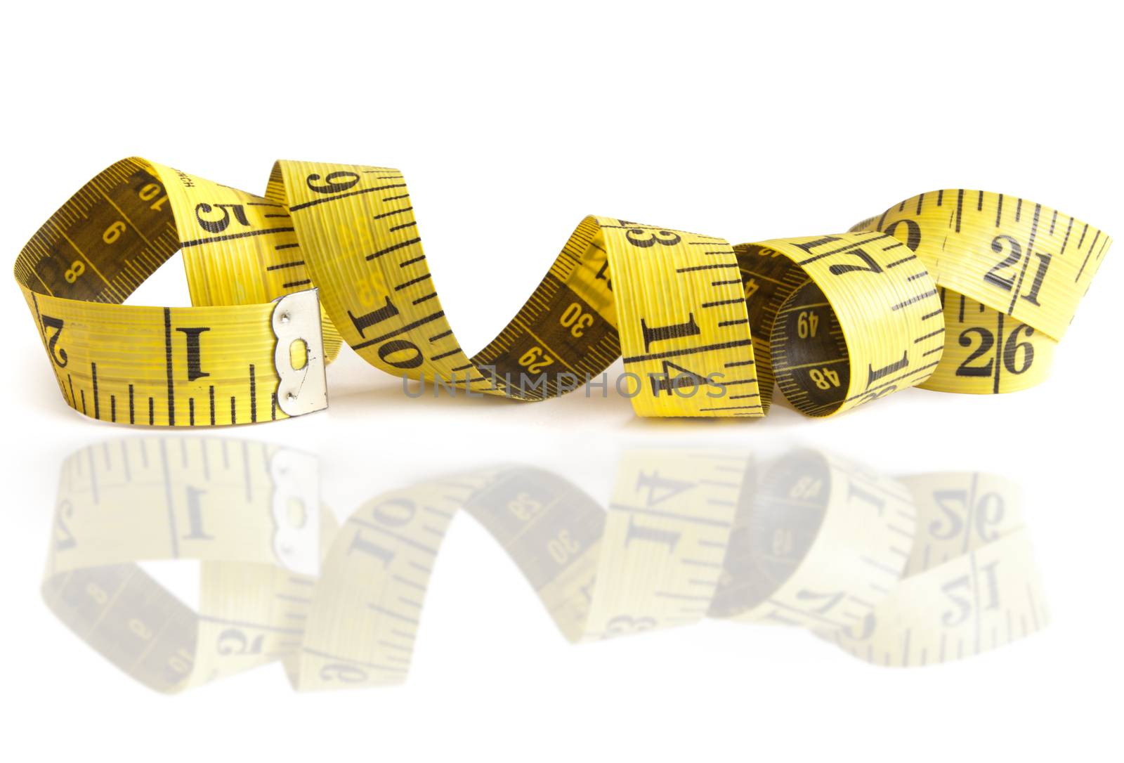 Measuring tape over a white background