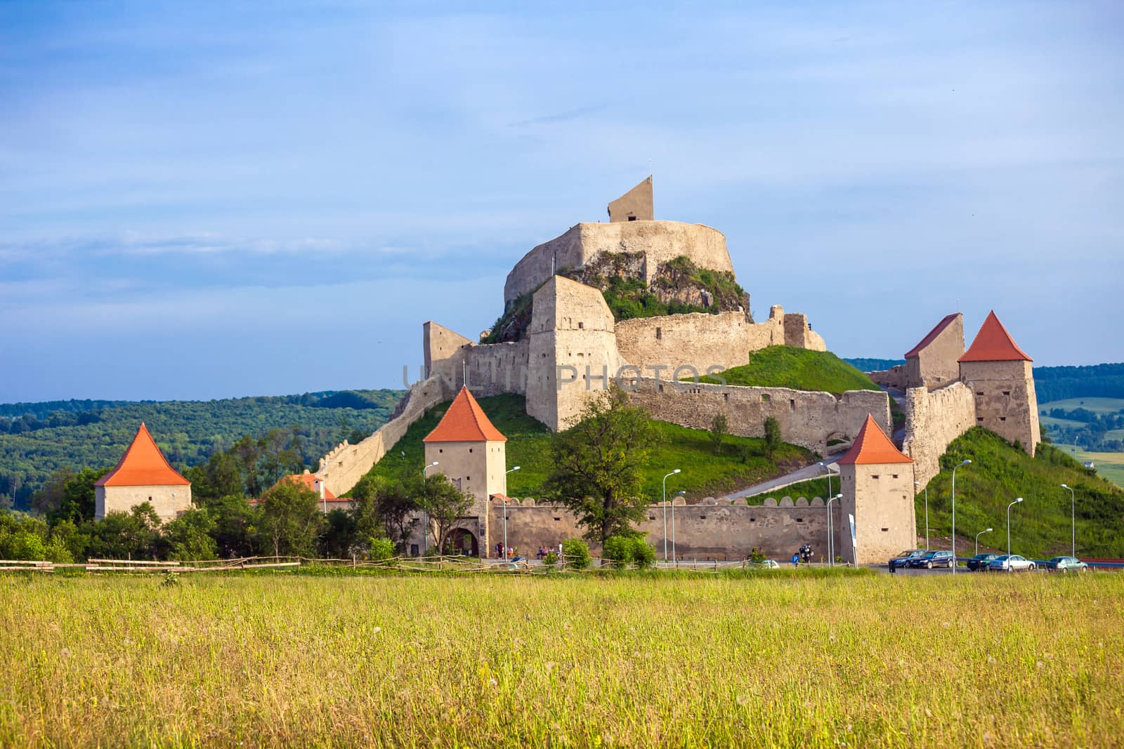 Rupea, Romania - June 23, 2013: Tourists visiting the old medieval fortress on top of the hill, Rupea village located in Transylvania, Romania