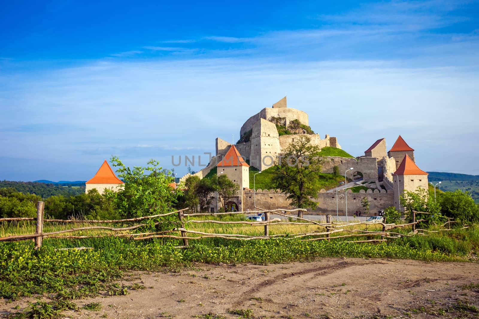Rupea, Romania - June 23, 2013: Tourists visiting the old medieval fortress on top of the hill, Rupea village located in Transylvania, Romania