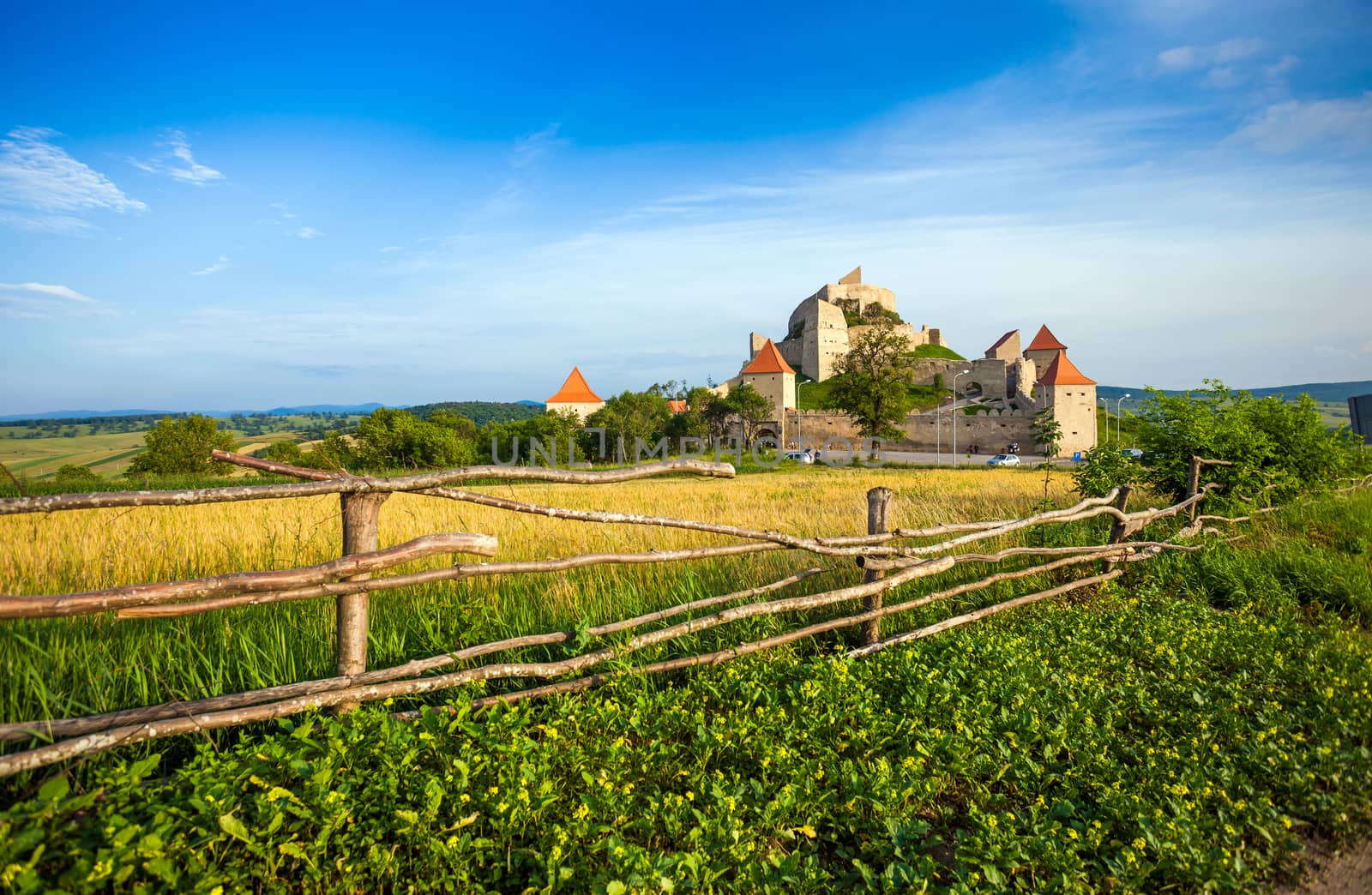 Rupea, Romania - June 23, 2013: Tourists visiting the old medieval fortress on top of the hill, Rupea village located in Transylvania, Romania