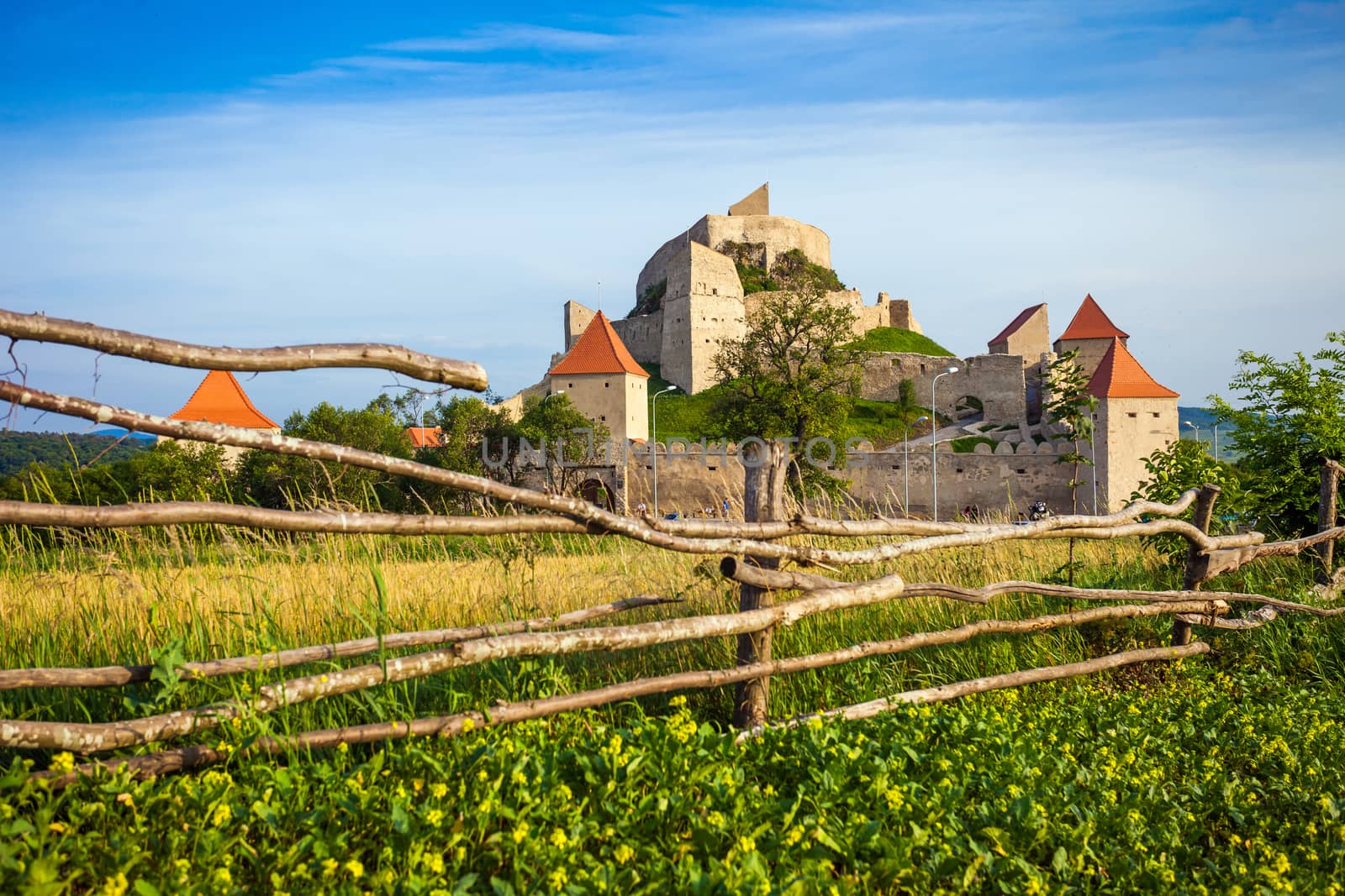 Rupea, Romania - June 23, 2013: Tourists visiting the old medieval fortress on top of the hill, Rupea village located in Transylvania, Romania