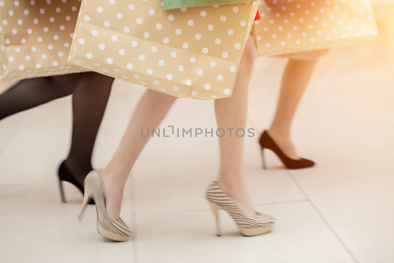 close up woman legs shopping in the city in motion blur