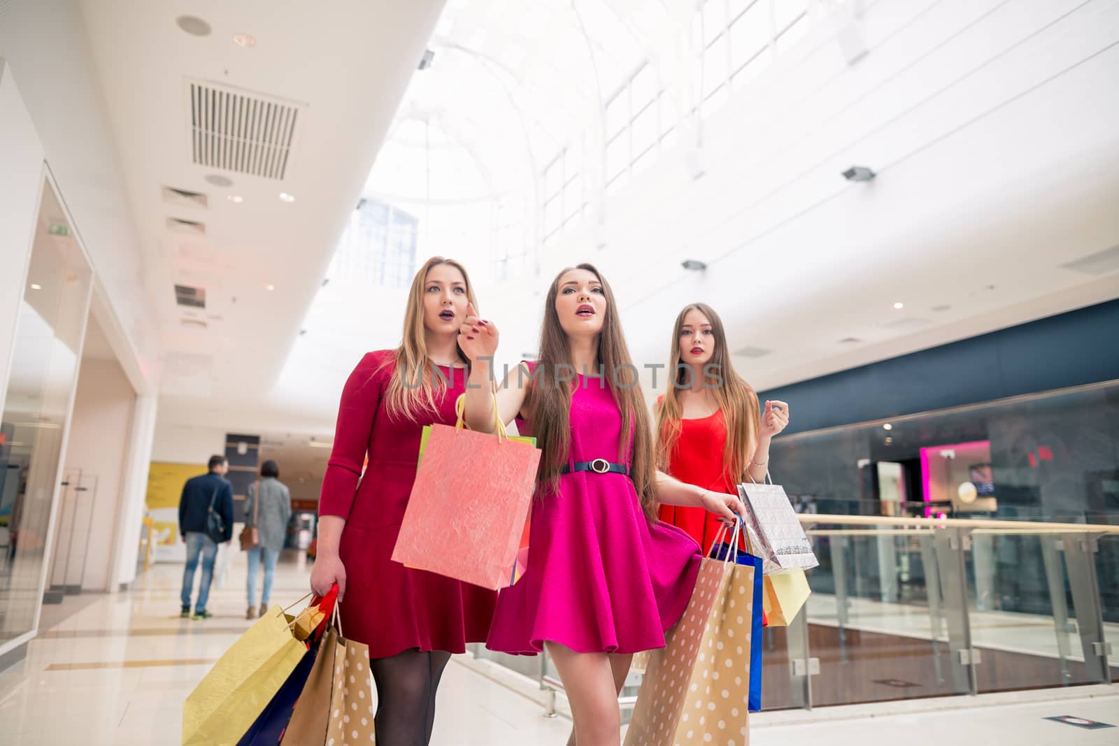 Beautiful girls with shopping bags walking at the mall