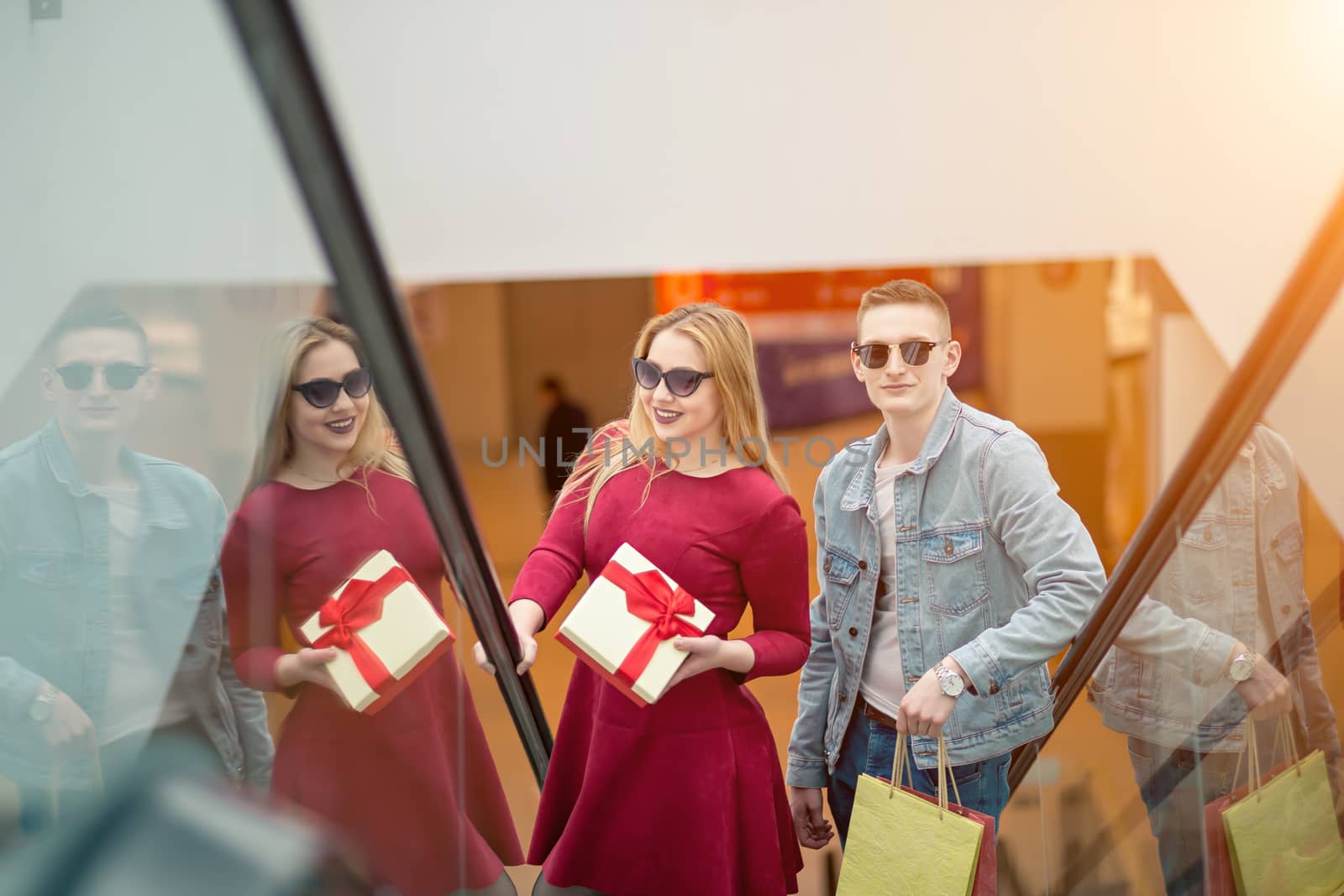 Female Shopper On Escalator In Shopping Mall