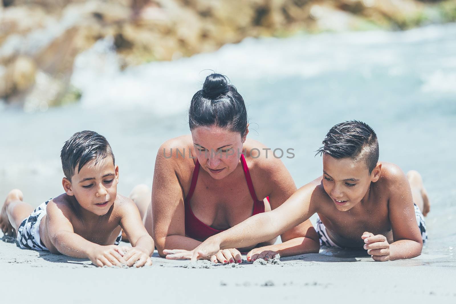 Mother and his two sons on the beach by nachrc2001