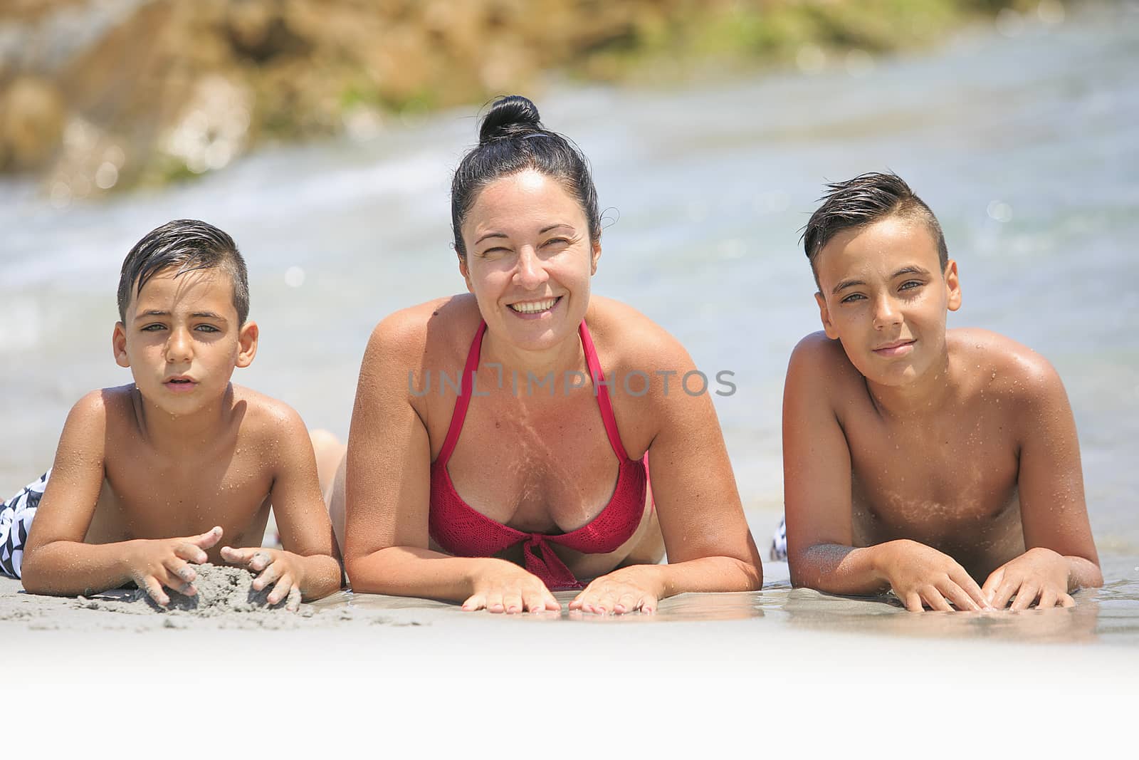 Mother and his two sons on the beach by nachrc2001