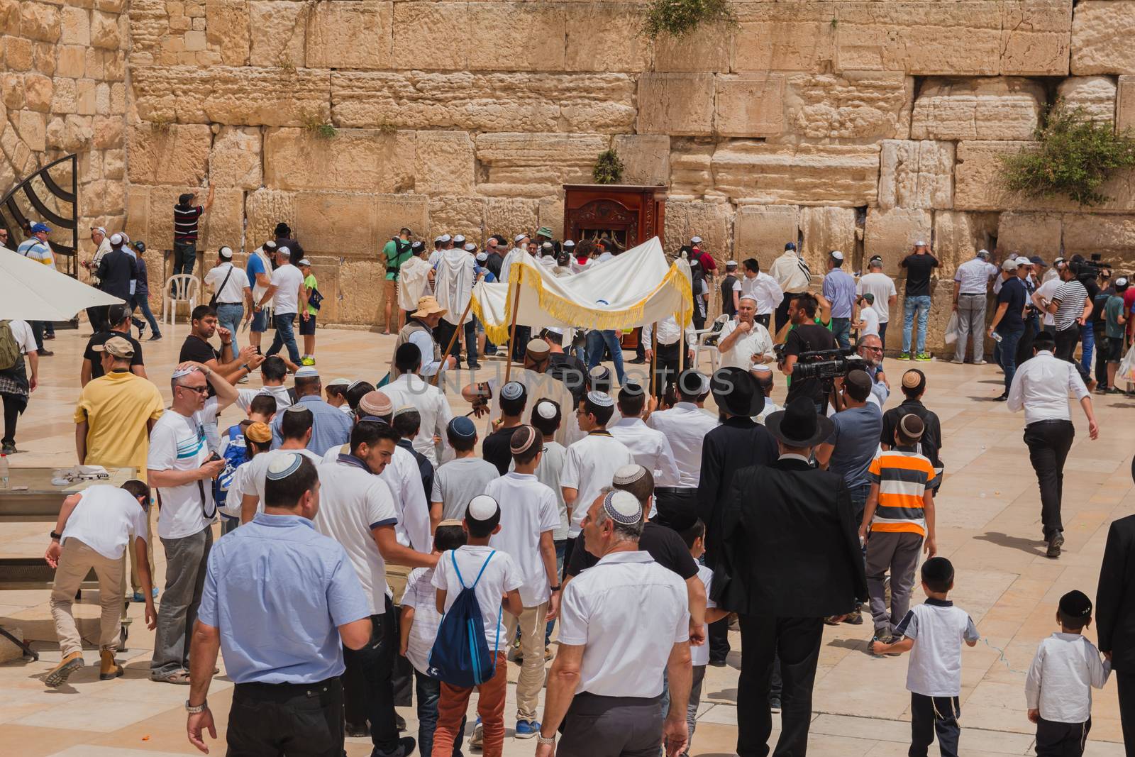 Jerusalem, Israel - May 9, 2016: Jewish worshipers gather for a Bar Mitzvah ritual at the Western wall in Jerusalem.