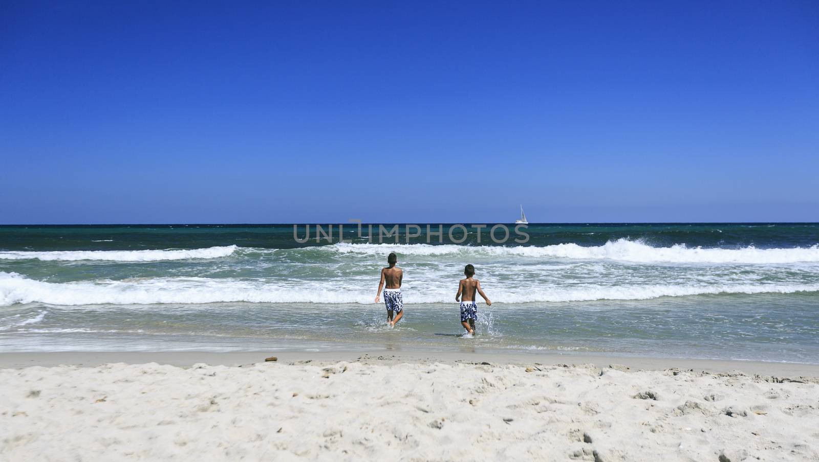 Boys playing on the beach by nachrc2001