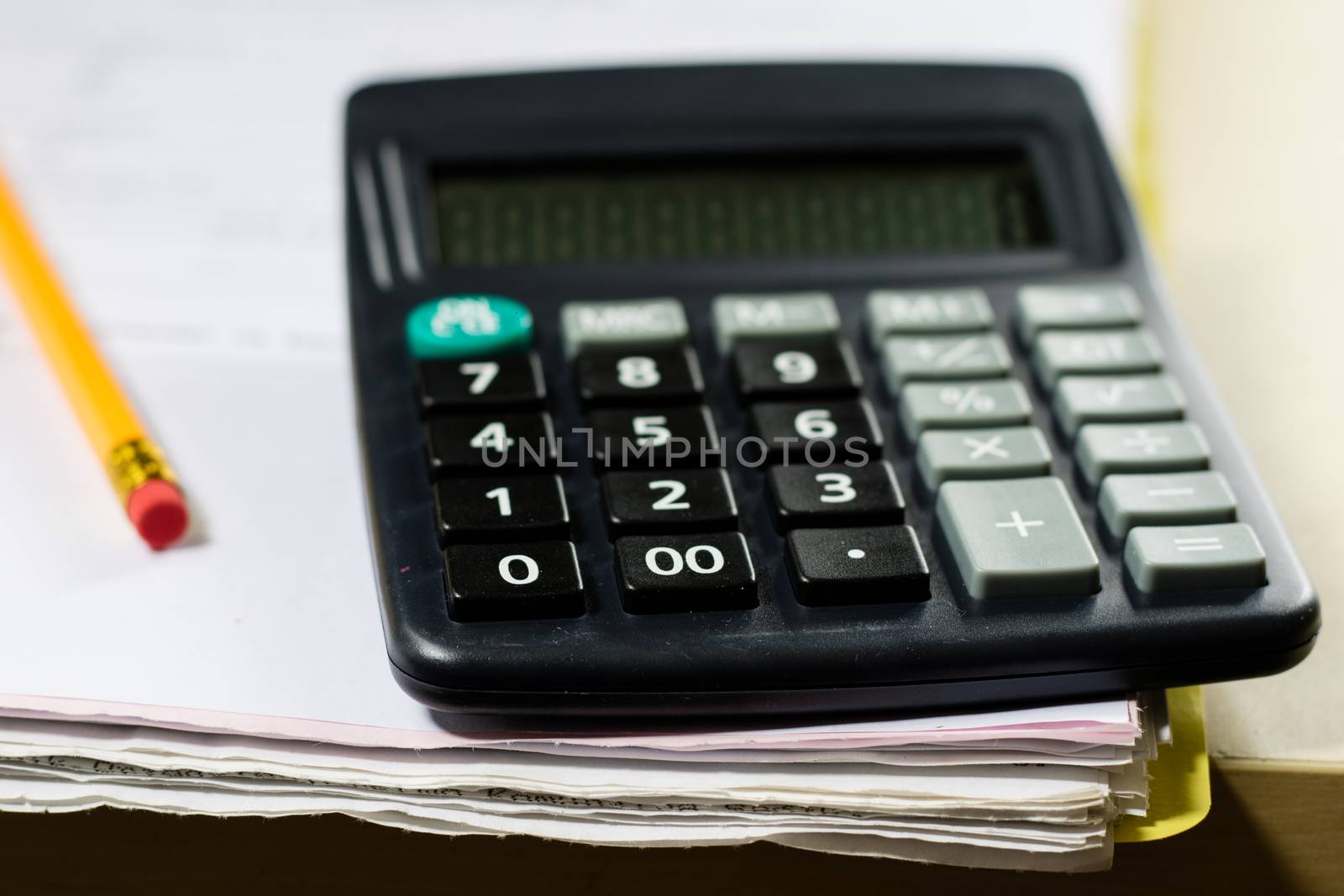 Bills, documents and papers with calculator. Office of the accounting office. Wooden table.