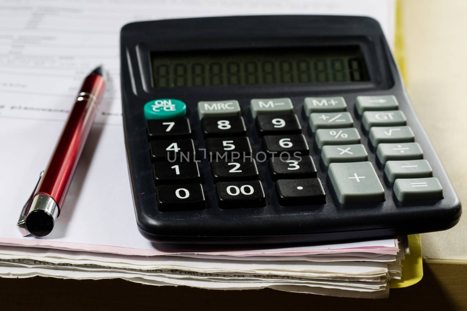 Bills, documents and papers with calculator. Office of the accounting office. Wooden table.