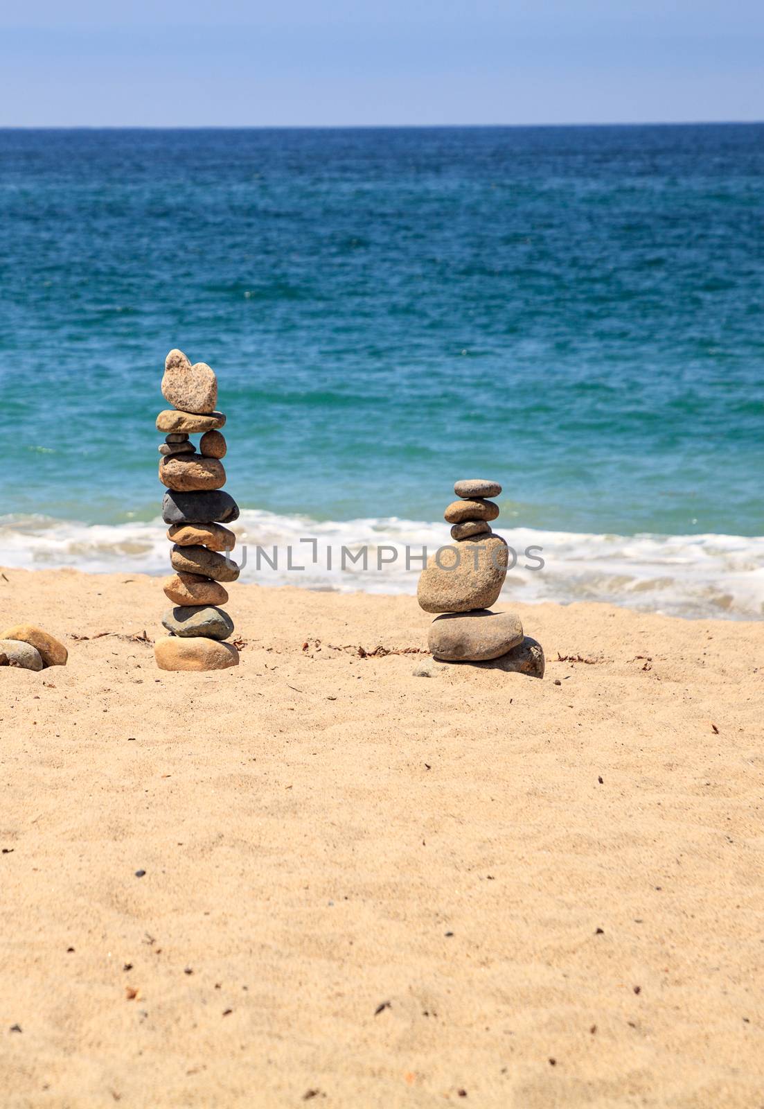 Stones piled on top of one another in Inuksuk fashion in summer at the San Clemente State Beach in Southern California