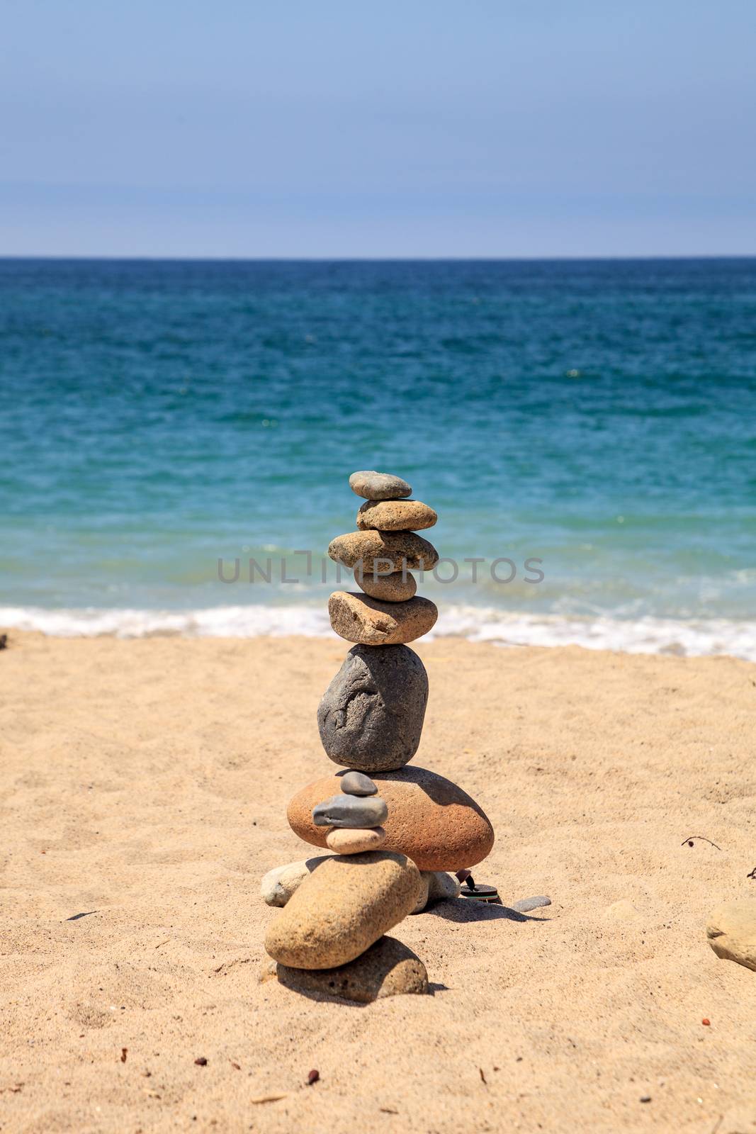 Stones piled on top of one another in Inuksuk fashion in summer at the San Clemente State Beach in Southern California