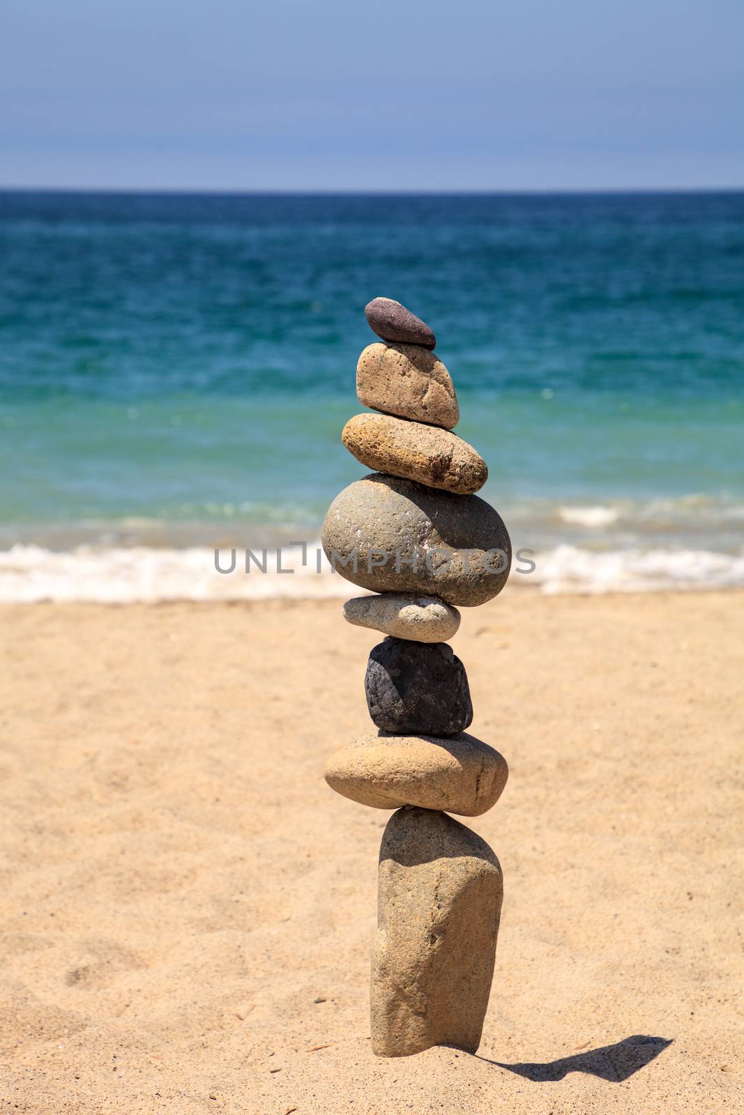 Stones piled on top of one another in Inuksuk fashion in summer at the San Clemente State Beach in Southern California