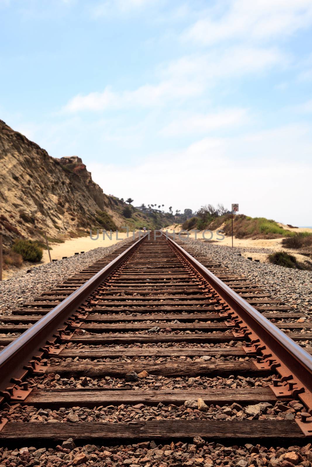 Train tracks run through San Clemente State Beach in Southern California in summer.