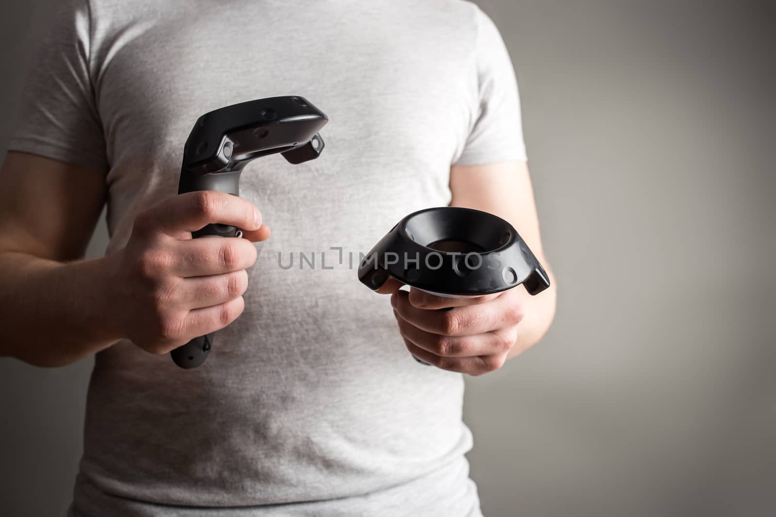 technology, gaming, entertainment and people concept - happy young man with virtual reality headset or 3d glasses with controller gamepad playing racing video game at home