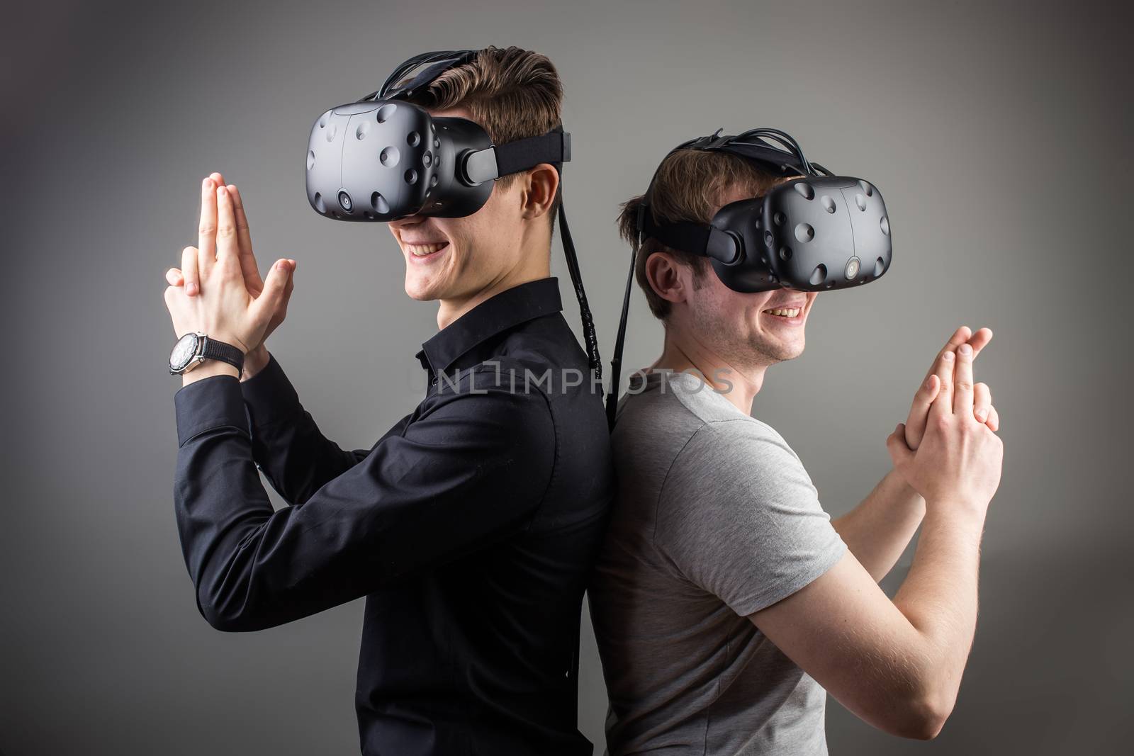 two young man playing game using virtual reality headset