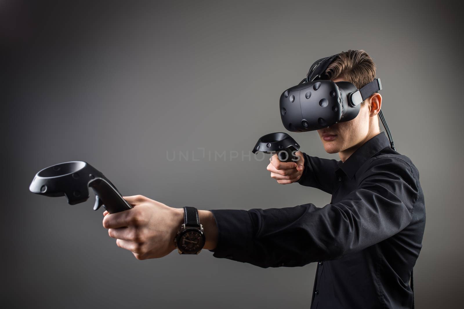 young man playing games with virtual reality goggles