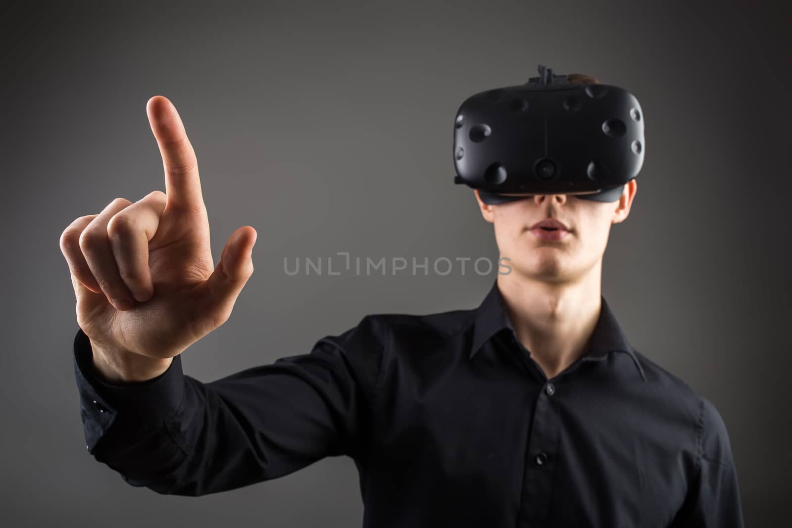 Male business executive using virtual reality headset by ufabizphoto