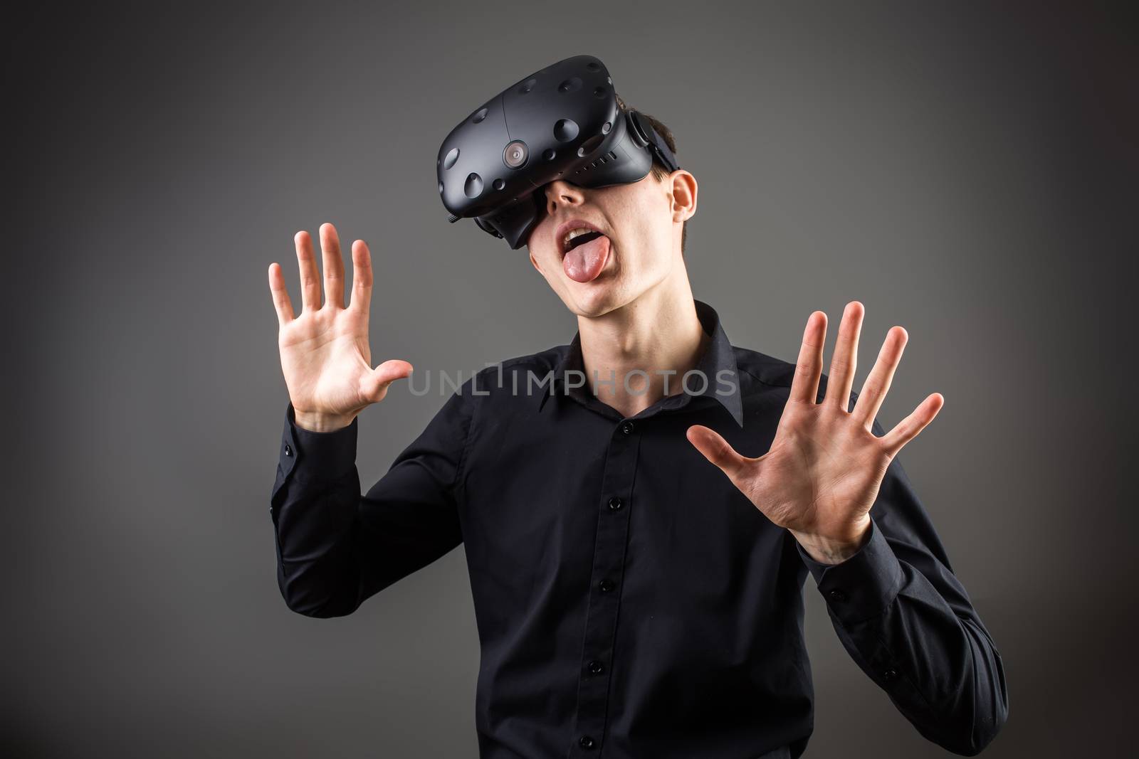 Businessman making gestures when wearing virtual reality goggles by ufabizphoto