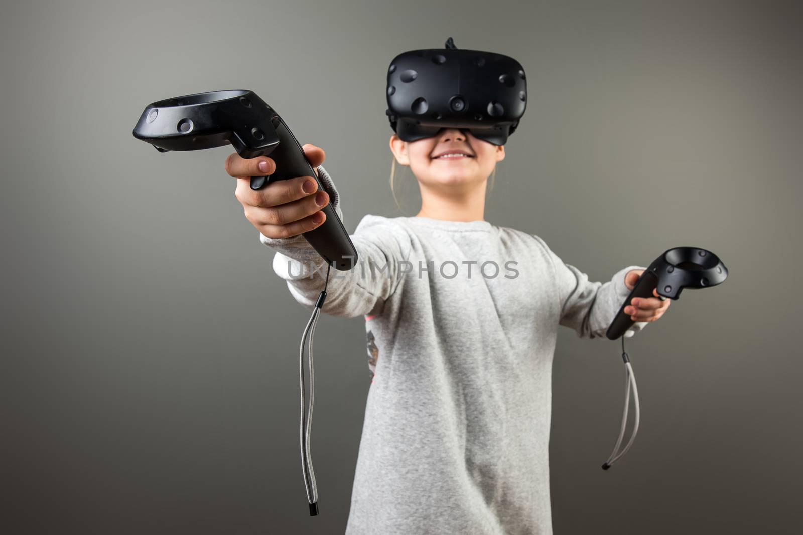 happy Child with virtual reality headset and joystick by ufabizphoto