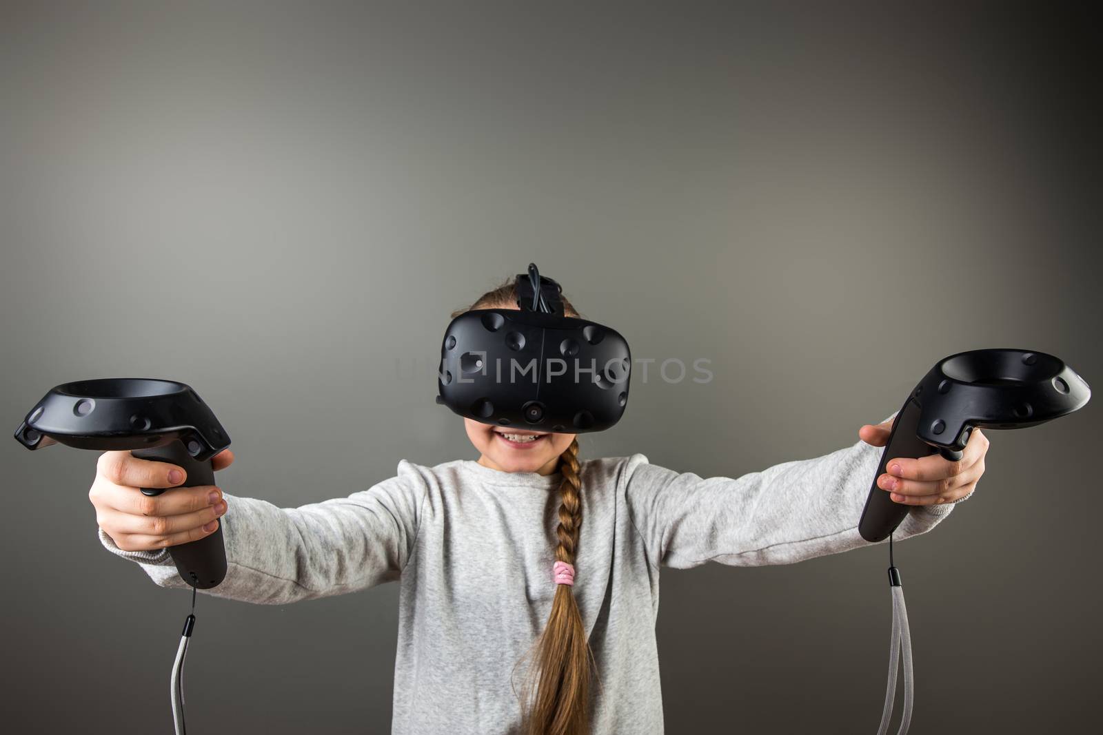 Child with virtual reality headset and joystick by ufabizphoto