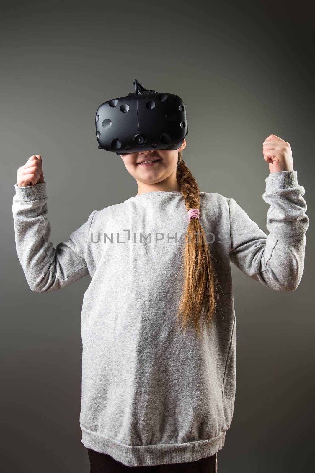 Happy little girl using a virtual reality headset