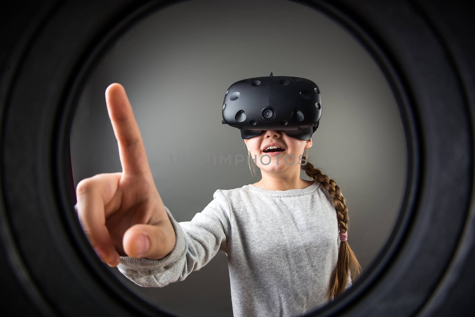 Happy little girl using a virtual reality headset