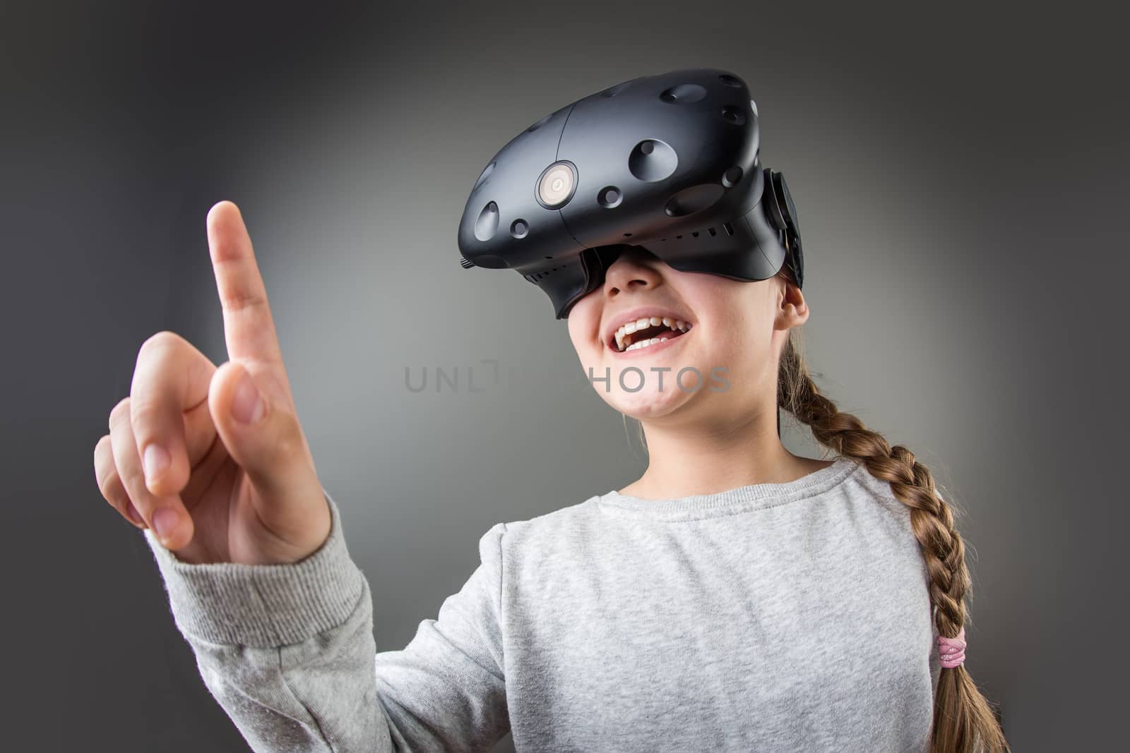surprised little girl using a virtual reality headset