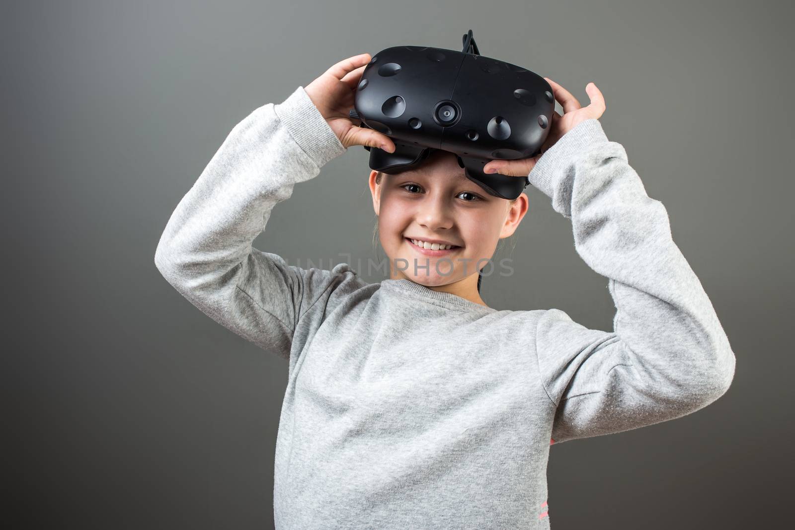 Happy little girl using a virtual reality headset