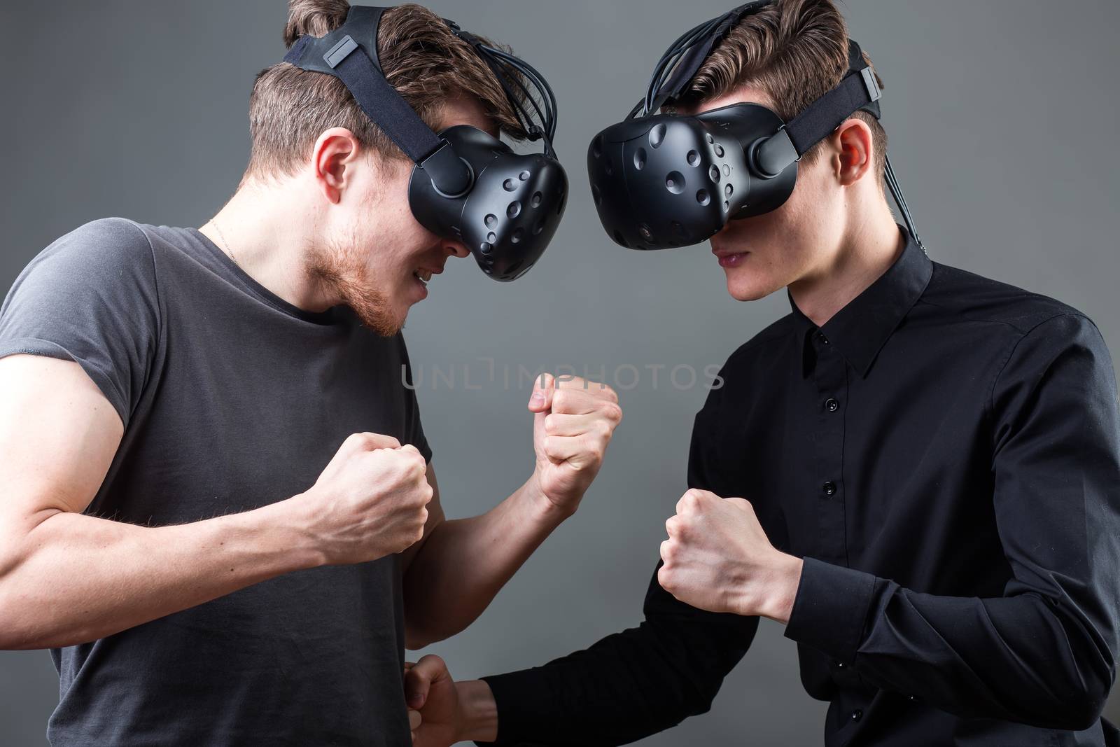 Shot of two young man standing with VR goggles. Developers testing virtual reality glasses by ufabizphoto