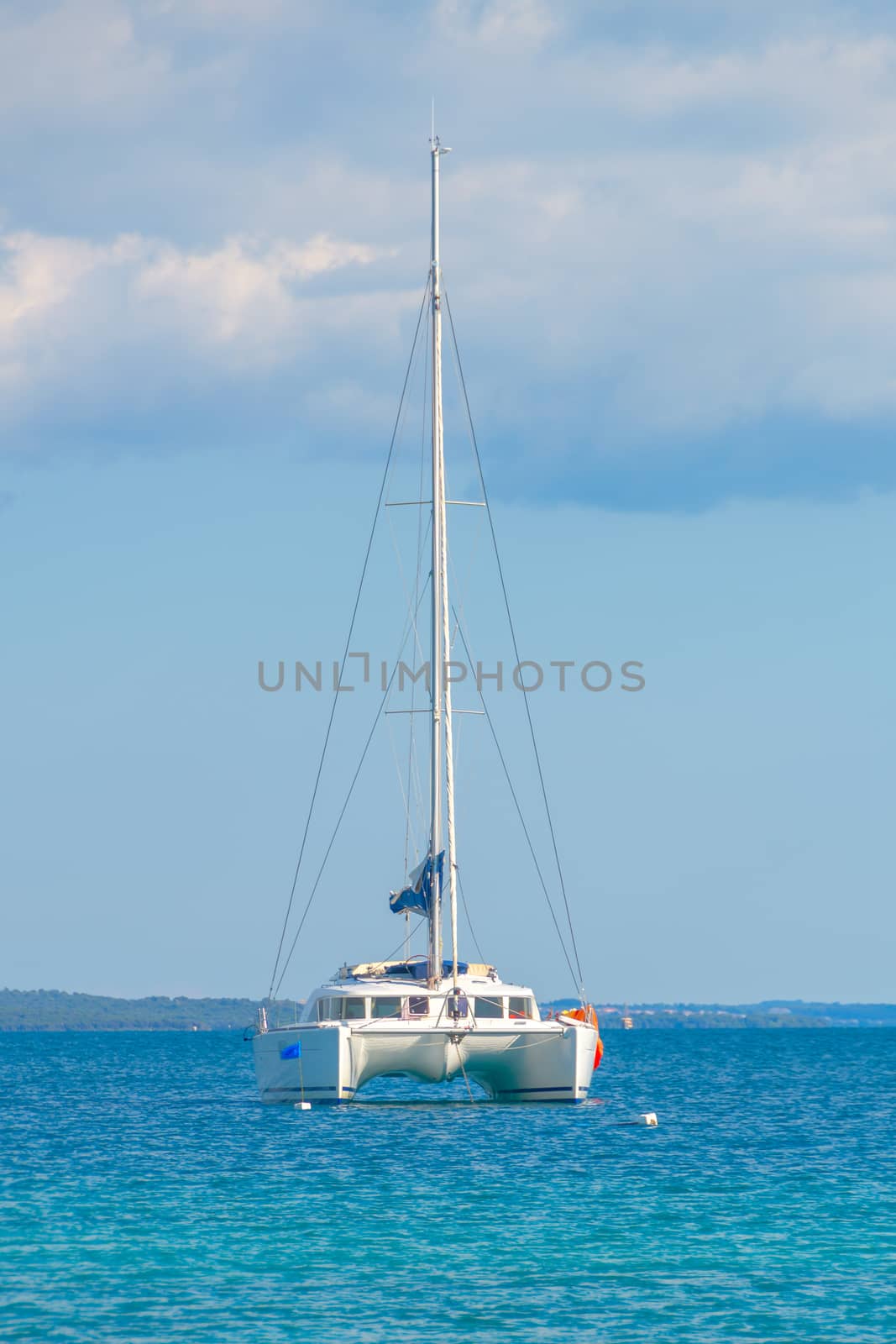 Luxury sailing catamaran in open sea by asafaric