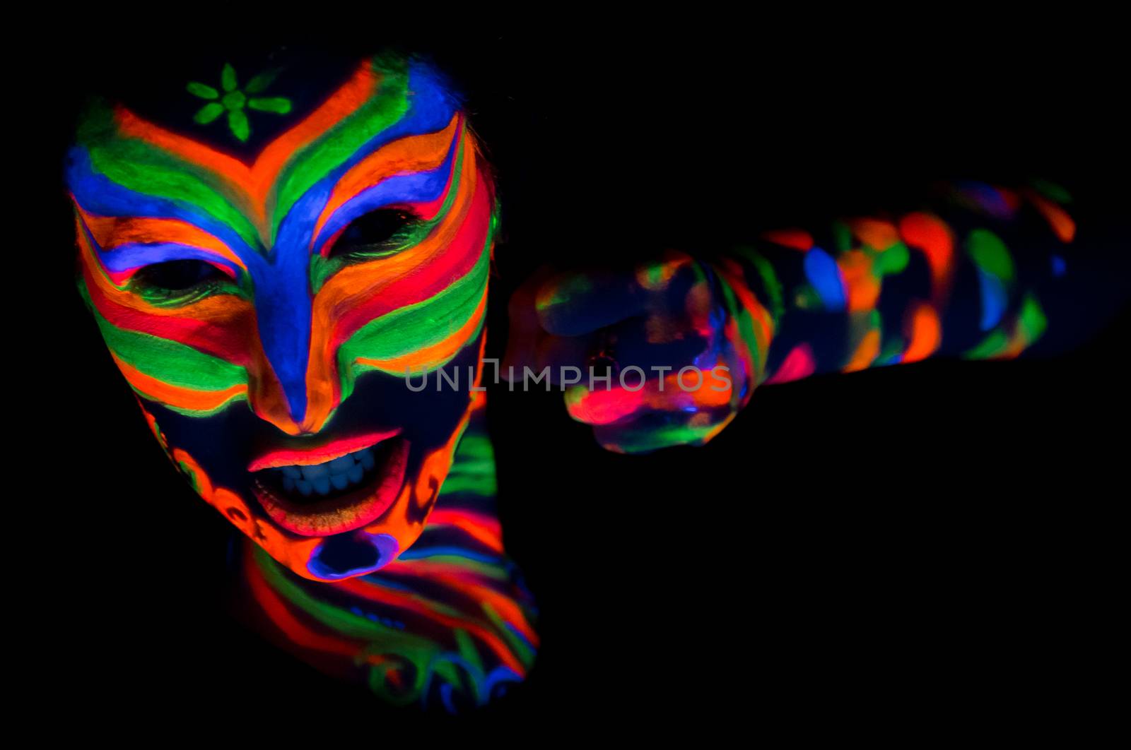 Woman with make up art of glowing UV fluorescent powder.