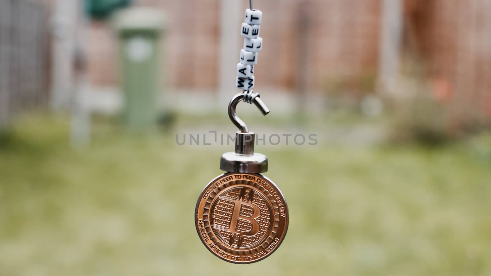 Digital currency physical metal bitcoin coin on the magnet with wallet inscription.