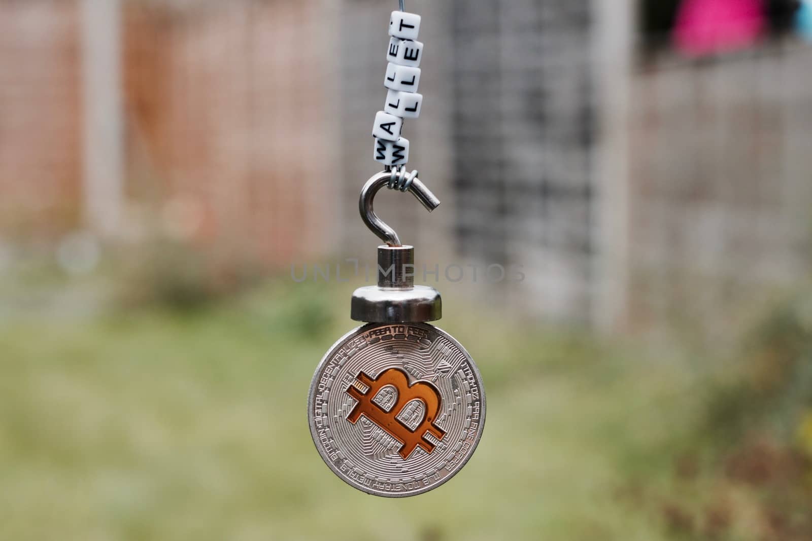 Digital currency physical metal bitcoin coin on the magnet with wallet inscription.