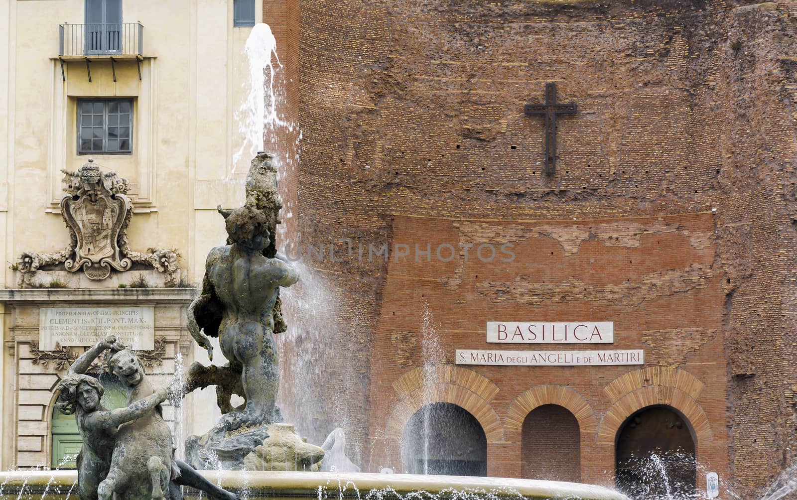 Detail of the fountain of Naiads in Piazza della Repubblica with the Basilica of St. Mary of the Angels and the Martyrs in background. Rome, Italy
