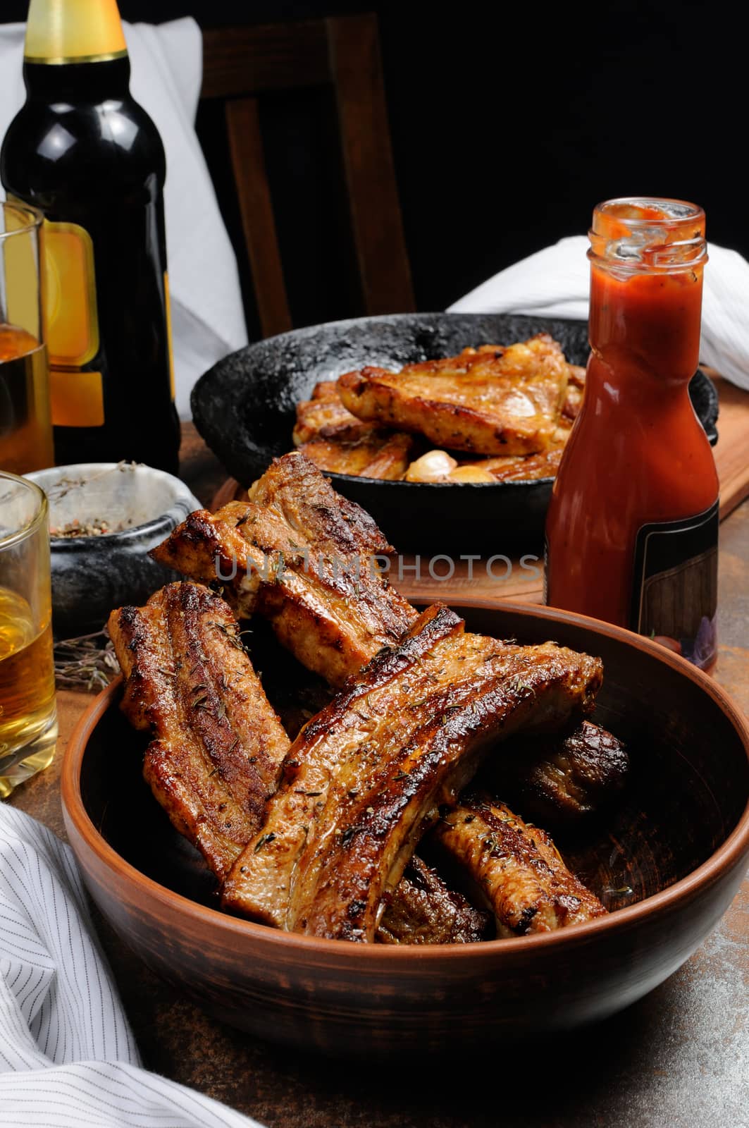 Fried spicy, sharp pork ribs with beer and ketchup. Vertical shot.