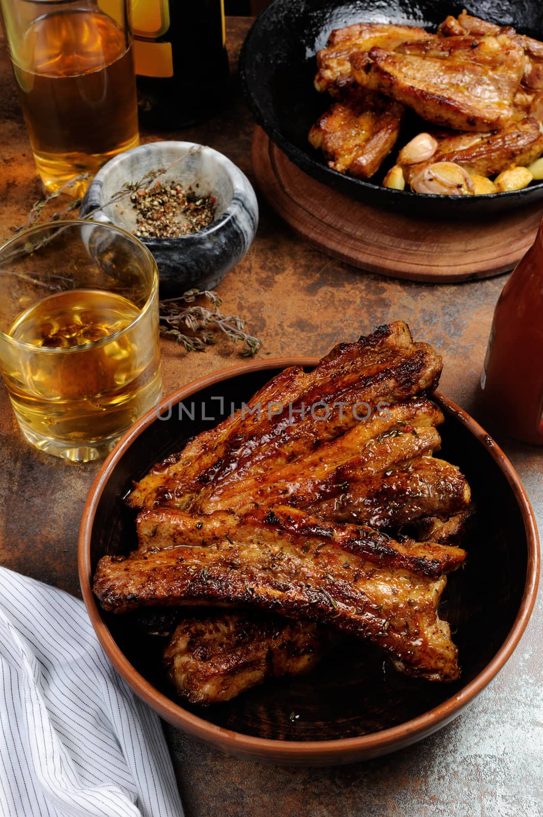 Fried spicy, sharp pork ribs with beer and ketchup. Vertical shot.