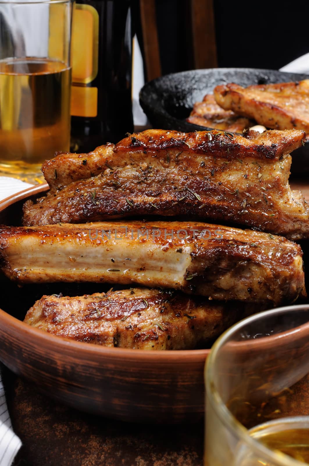 Fried spicy, sharp pork ribs with beer and ketchup. Vertical shot.