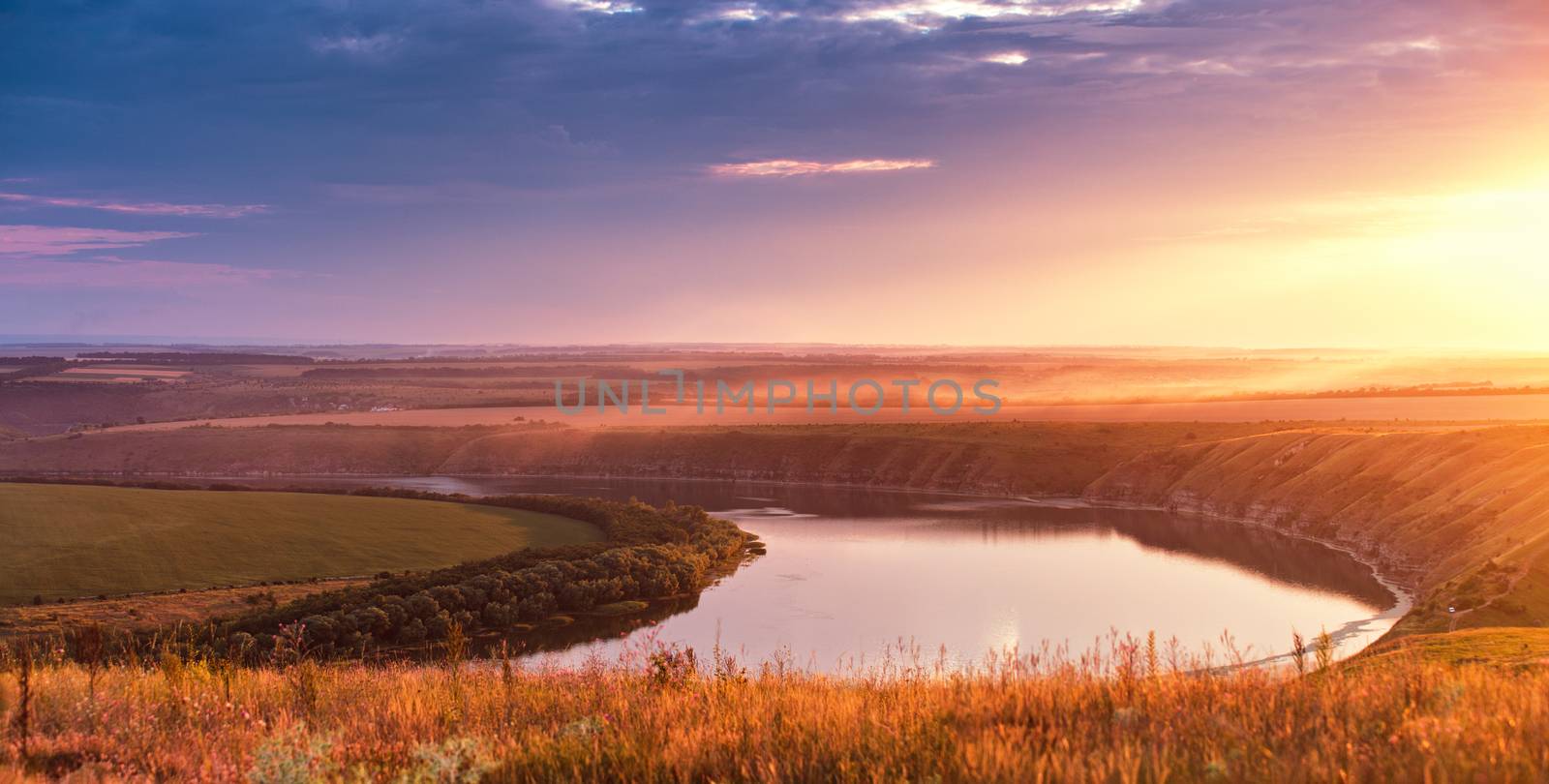 Summer panorama of river in canyon. Panoramic view from the hill on bend of the river Dniester at sunset. 