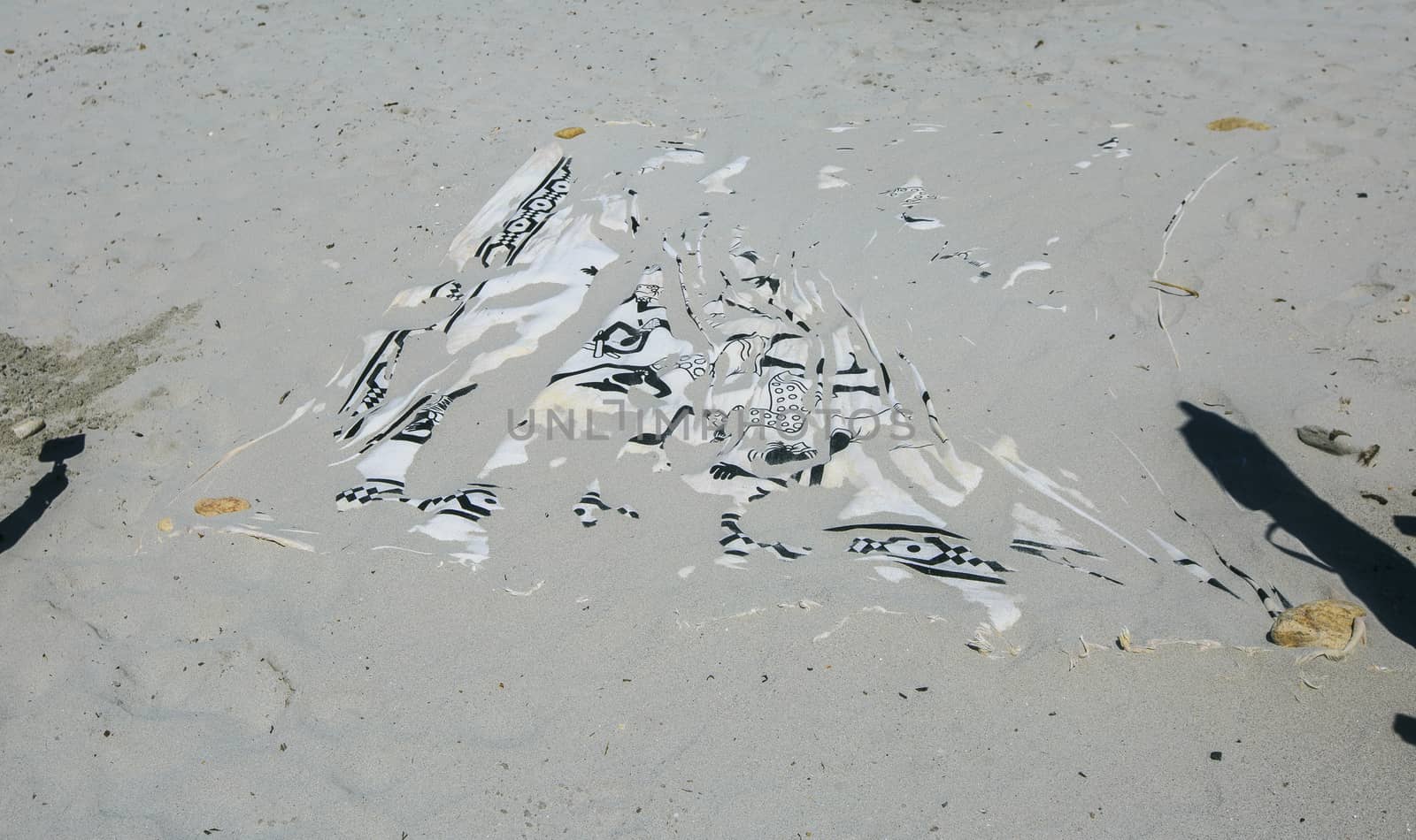 towel buried on the sand of the beach by nachrc2001