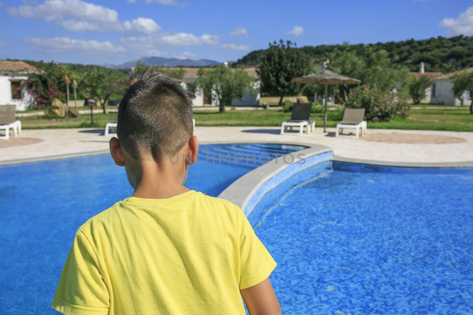 Boy  walking over the swimming pool