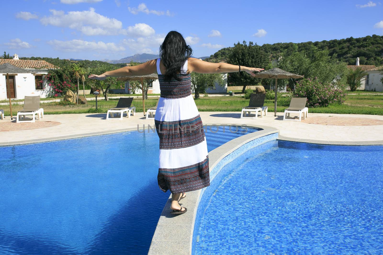 Girl walking over the swimming pool