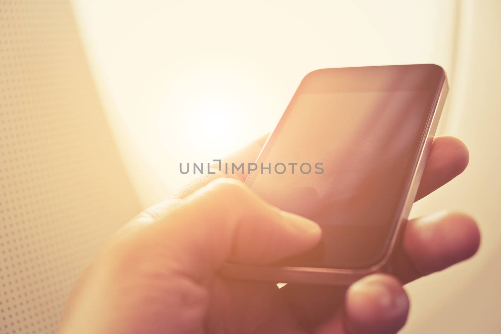 close up of business man sit in airplane watching his cell phone, Doing business the modern way concept background