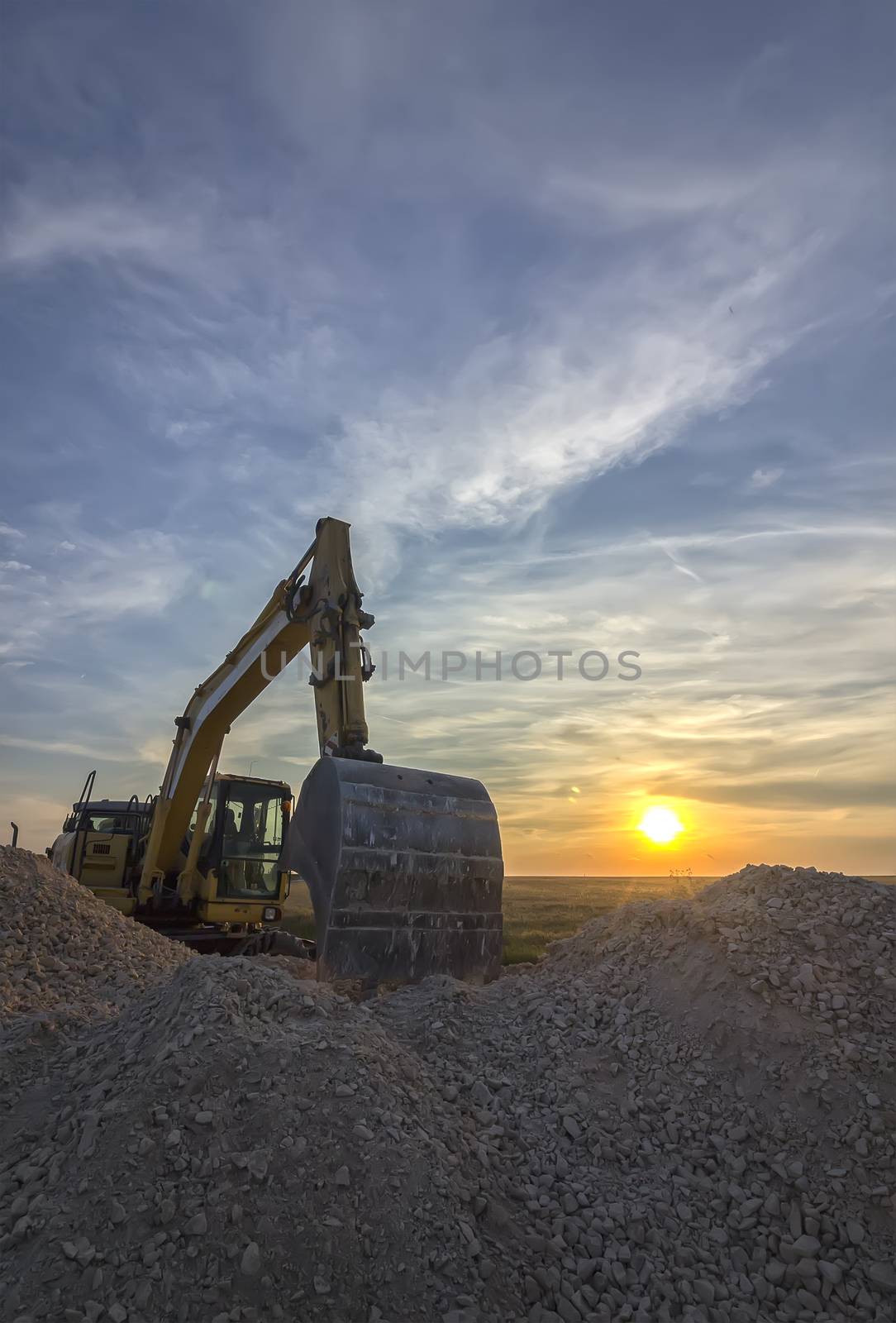 excavator in construction site at stunning sunset