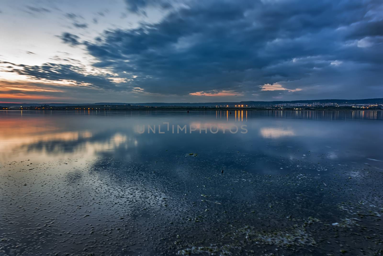 blue hour. Stunning long exposure landscape with city lights at horizon