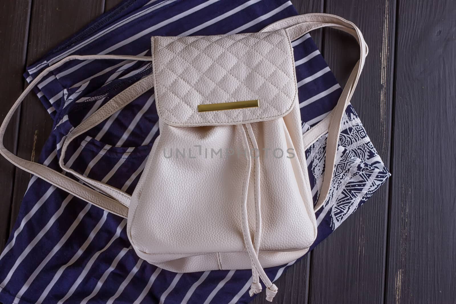 White Leather Women's Backpack on a Striped T-shirt