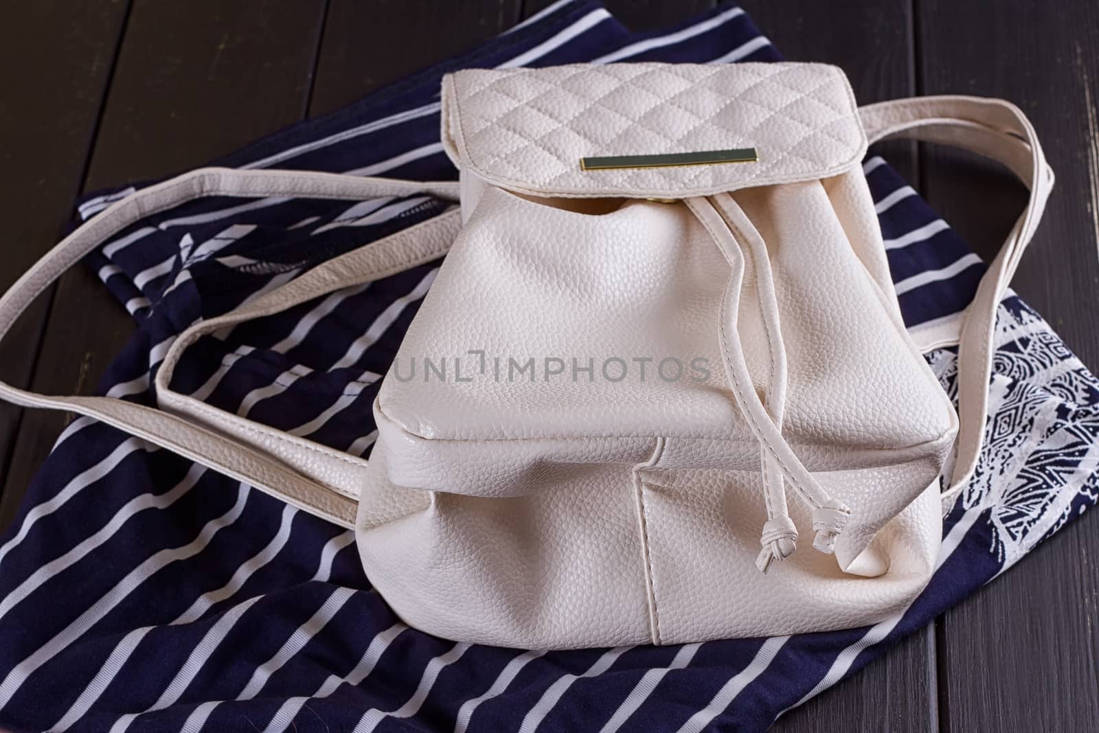 White Leather Women's Backpack on a Striped T-shirt