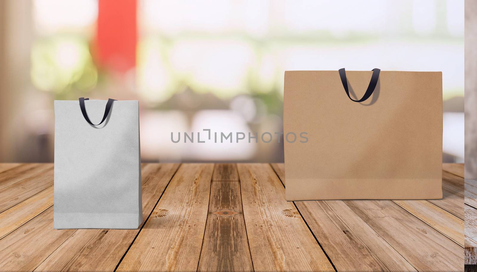 Two paper bags for shopping on a wooden background