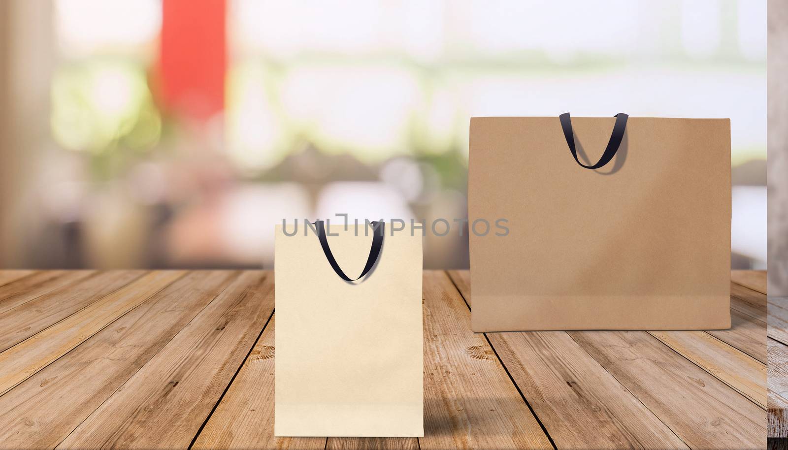 Two paper bags for shopping on a wooden background